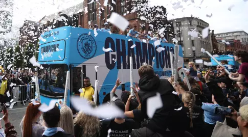 Manchester City players celebrate on the roof of the bus (Reuters)